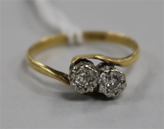 An 18ct gold and platinum, two stone illusion set diamond crossover ring, size N.